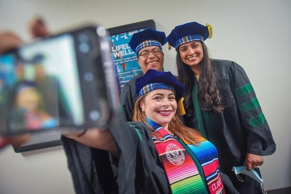 Members of the class of 2022 take a selfie at commencement