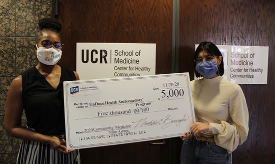 CHC presenting a check to a student researcher