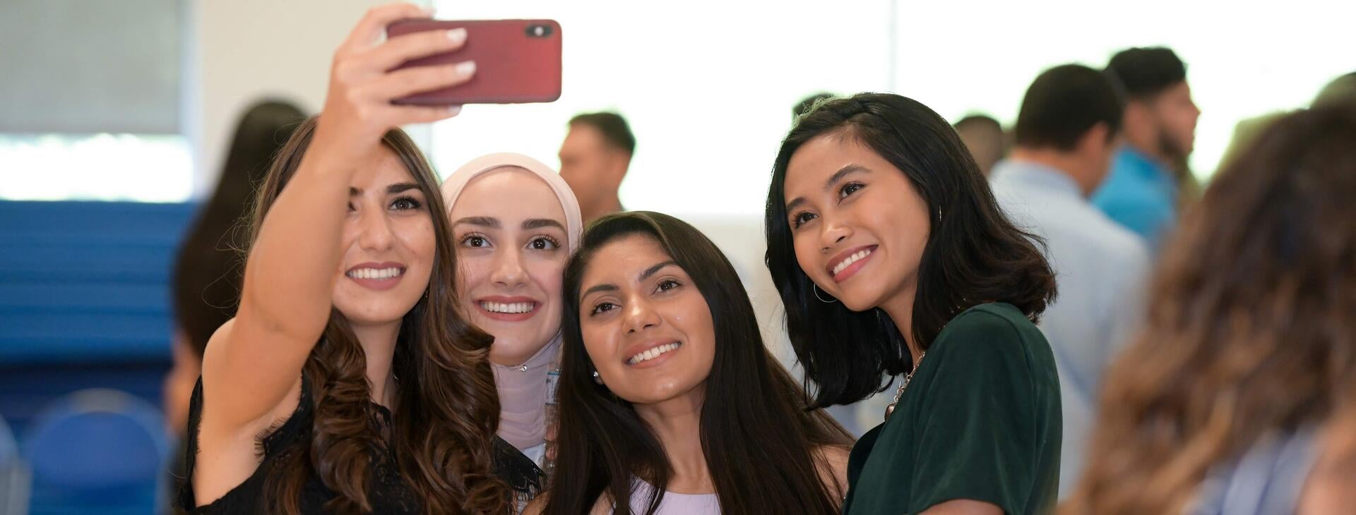 students taking a selfie at 2019 White Coat Ceremony
